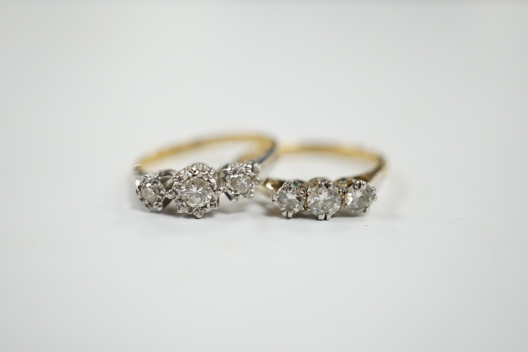 Two 18ct, plate and illusion set three stone diamond rings, sizes O & P, gross weight 6.3 grams. Condition - fair to good